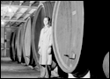 Man standing in front of a massive wine barrel 