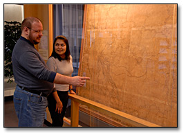 Photo: Two researchers viewing David Thompson's 'Great Map'