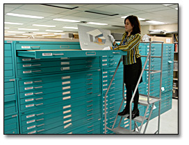 Photo: Archivist retrieving an architectural record in the special collections stack