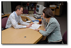 Photo: A reference archivist conducting a reference interview with a researcher