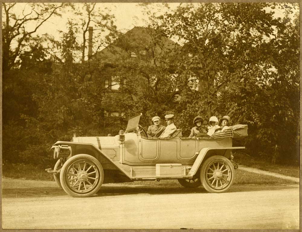 Group portrait in car, with Herbert Coleman McEachern in front passenger seat 
