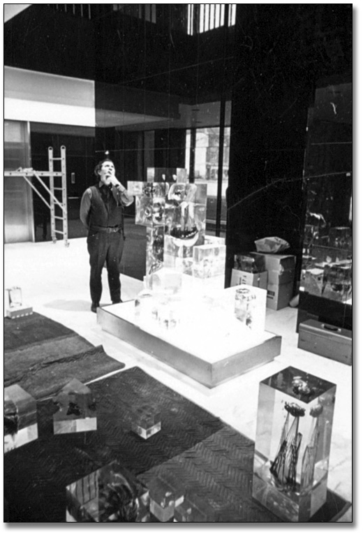 Photo: Gerald Gladstone installing his sculpture, Galaxy Series #2 '67, in the Lobby of the Macdonald Block, 1968