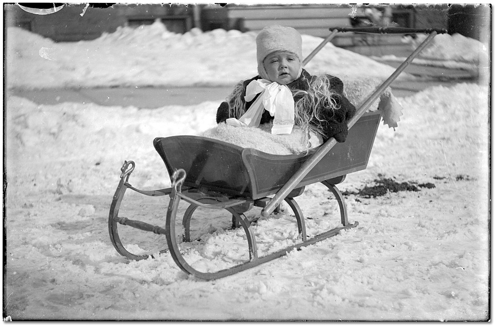 Photo: Child on pull sleigh, [191-?]