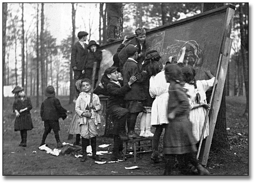 Photo: School children crowding the blackboard at recess, [ca. 1917]