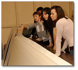 Photo: Conservators Examining Frame