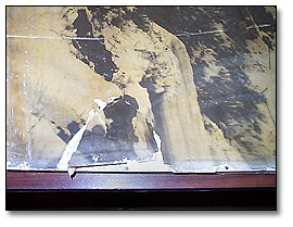 Photo: Mechanical damage. Detail showing a detached piece of the photograph.