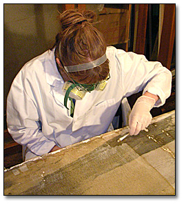 Photo: Conservator removes varnish from one of the Freeland panoramas