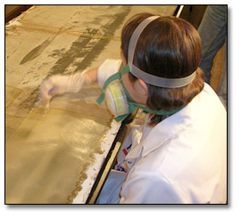 Photo: Conservator removes varnish from one of the Freeland panoramas.