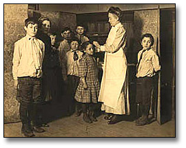 Photo: Children being washed by a nurse at school, [ca. 1905]