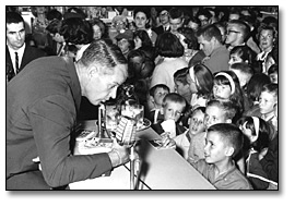 Photo: " Signed, Mr. Hockey" Gordie Howe greets young fans at the Eaton's store, Shopper's World, Don Mills, Ontario [ca. 1965]