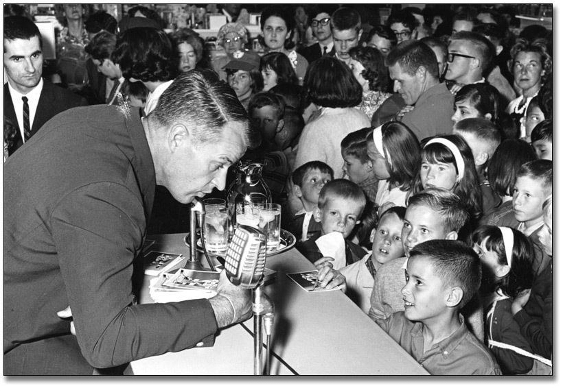 Photo: " Signed, Mr. Hockey" Gordie Howe greets young fans at the Eaton's store, Shopper's World, Don Mills, Ontario, [ca. 1965]
