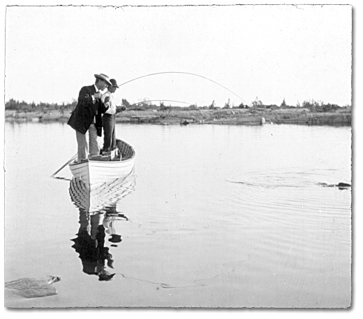 Photo: Two men fishing in a boat, [ca. 1905]