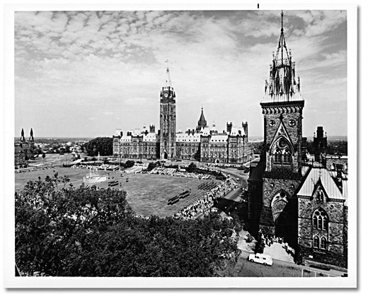 Photo: Canada’s Parliament Buildings form a perfect background for the Changing of the Guard Ceremony seen by visitors to the capital, Ottawa, [197-]