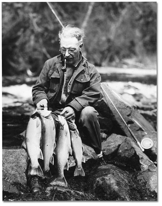 Photo: Tourist sitting with the fish he has just caught at a summer resort in Northern Ontario, [ca. 1930]