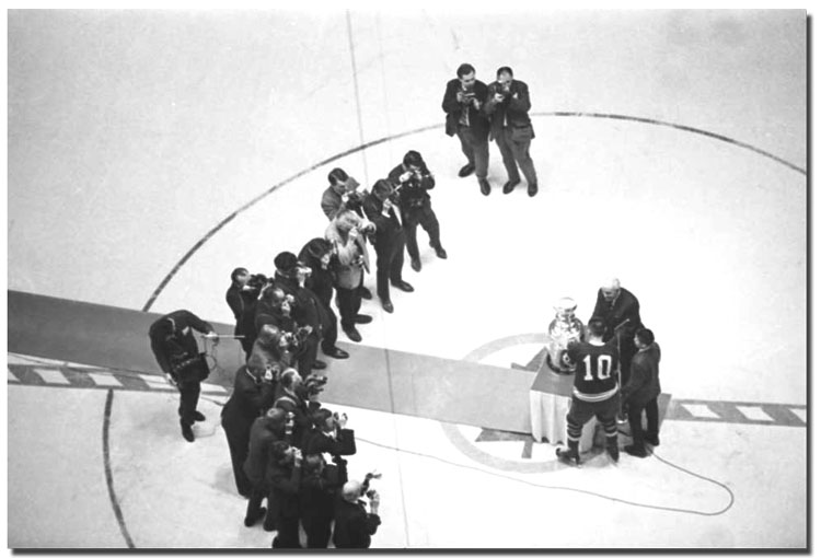 Toronto Maple Leafs captain George Armstrong receiving Stanley Cup in front of photographers, May 2, 1967 (67122-37)