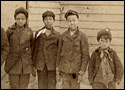 Detail of a photograph of black boys standing front of a school