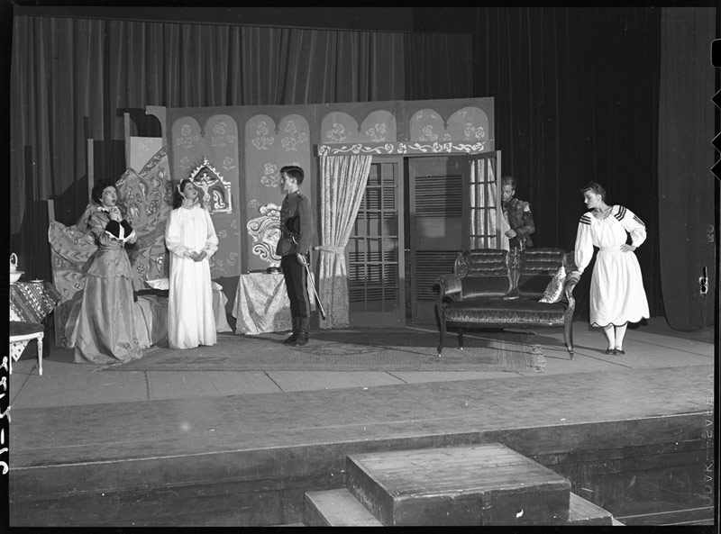 Five white actors performing on stage at Hart House Theatre at University of Toronto in 1946.
