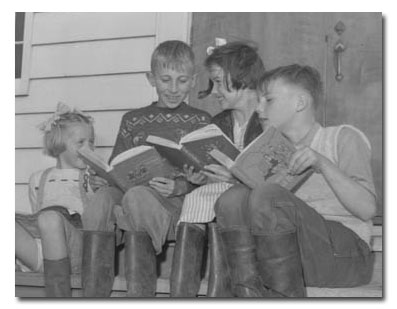 Children reading on the school steps, Holland Marsh