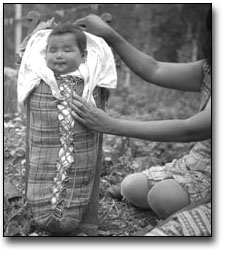 Photo: Baby in carrier, Sandy Lake, 1956