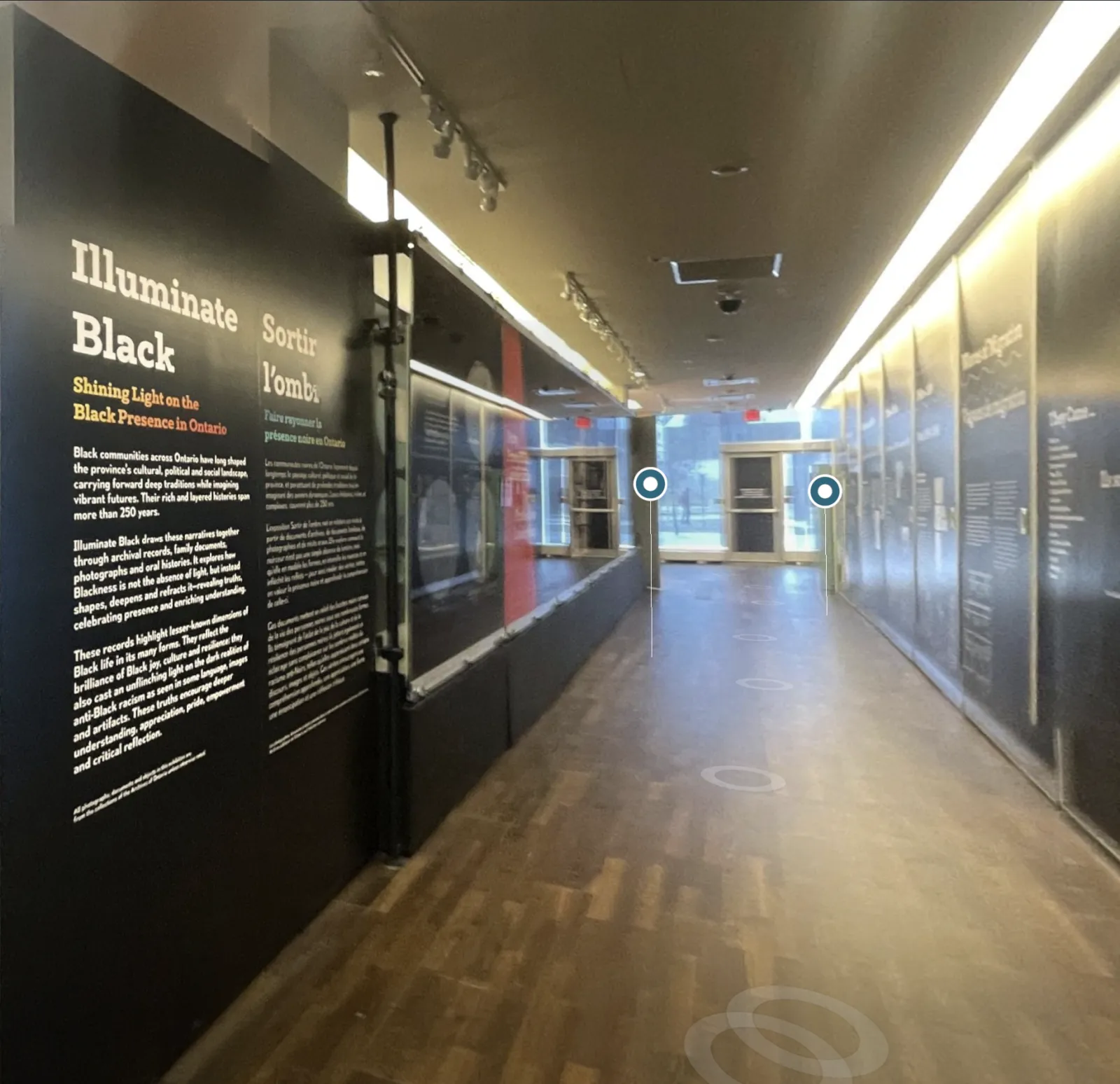 Hallway inside the Illuminate Black exhibition featuring historical displays about Black presence and history in Ontario.