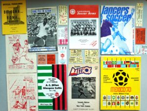 Colour photograph of a collage of historic soccer programs, tickets and memorabilia from international matches played in Toronto, featuring clubs, tournaments and visiting teams from around the world.