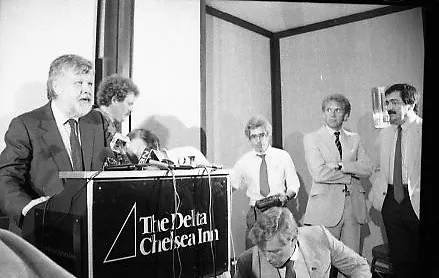 Black-and-white photo of the general manager of the Blizzard standing at a podium, delivering an announcement to the public and assembled reporters.