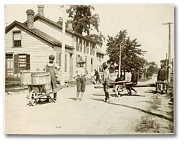 Photo: Boys with wheelbarrows in the streets of Amherstburg, Ontario [ca. 1895]