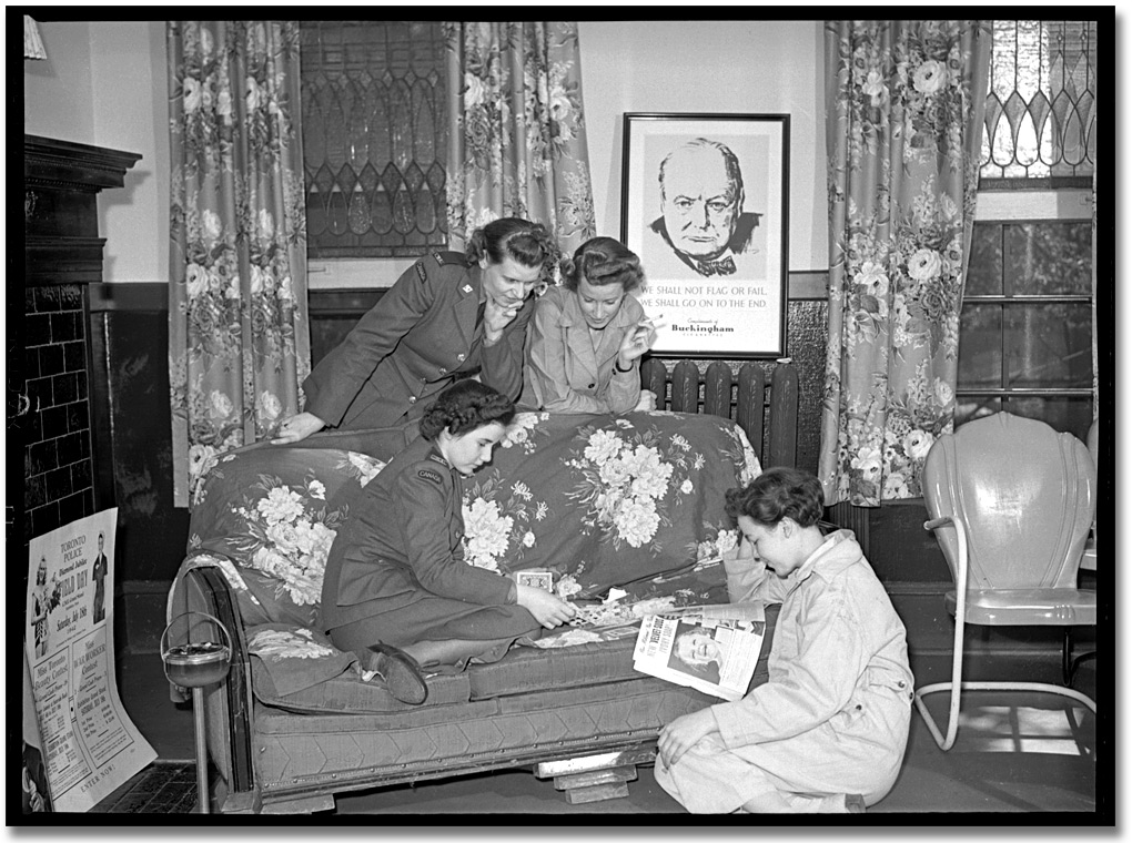 Photo: Members of the Canadian Women's Army Corps (C. W. A. C.) reading magazines in a lounge in the Trinity Barracks, [ca. 1945]