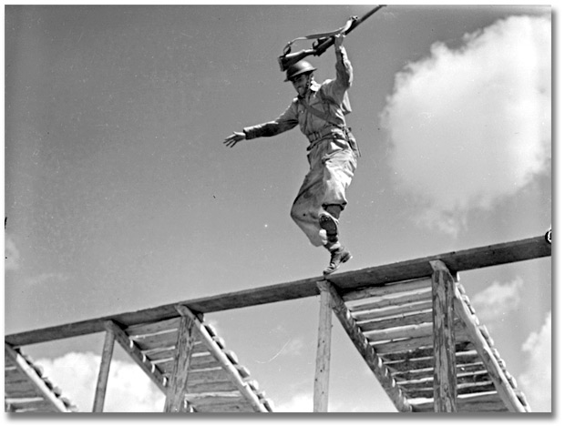 Photo: Soldier jumping from obstacle during training [ca. 1945]