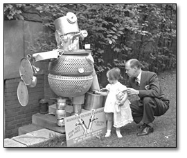 Photo: The Aluminum Victory Campaign, 1941 [man and girl looking at sculpture made out of aluminum]