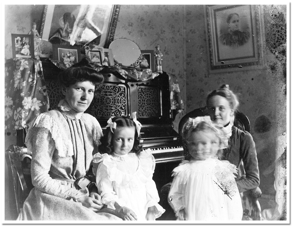 Photo: The Clows inside by their piano, [between 1898 and 1920]