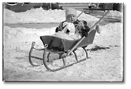 Photo: Child on pull sleigh, [191-?]