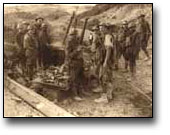 Photographie : Soldat canadien grièvement blessé à l'épaule et à la jambe buvant un café chaud, dans une soupe populaire, à environ 100 mètres des lignes allemandes, à Colline 70, [vers 1918]