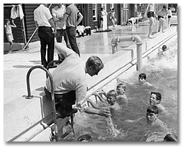 Photo: Public Health Inspector testing water quality of a public swimming pool in the New Liskeard - Kirkland Lake area, 1969