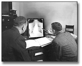 Photo: Two men viewing a chest x-ray at a Board of Health laboratory, [ca. 1928]