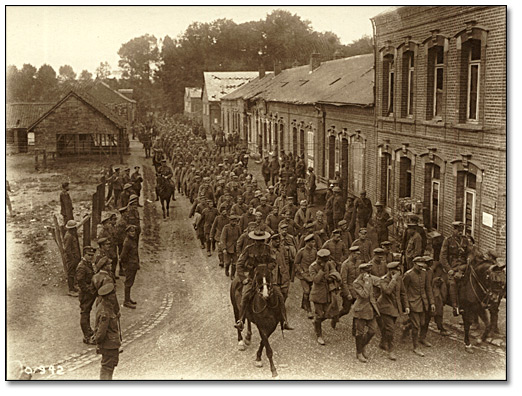 Photo: German prisoners taken by Canadians on the Somme being escorted to the prisoner's cages by Canadian Military Police, 1916