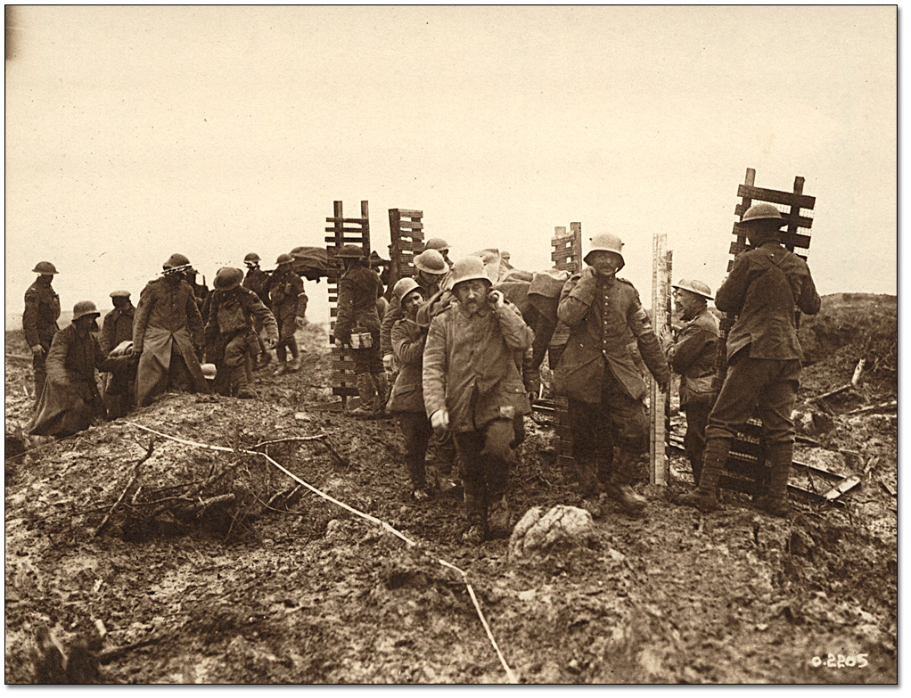 Photo: Canadian Pioneers carrying trench material to Passchendaele quiting work while German prisoners carrying wounded pass by, 1917