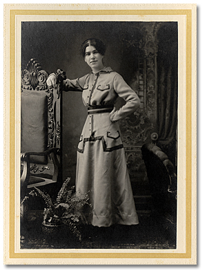 Portrait of an unidentified young woman posing beside a chair, [between 1900 and 1920]