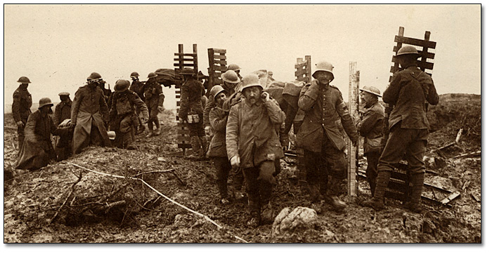 Canadian Pioneers carrying trench material to Passchendaele quiting work while German prisoners carrying wounded pass by, 1917