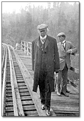 Sir Wilfrid Laurier by a railway track Date: 1910