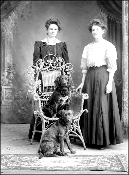 Katie Thorburn and Mary Macdonald with two dogs, 1908 