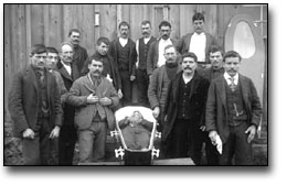 Black and white photograph of a group of men gathered around a casket