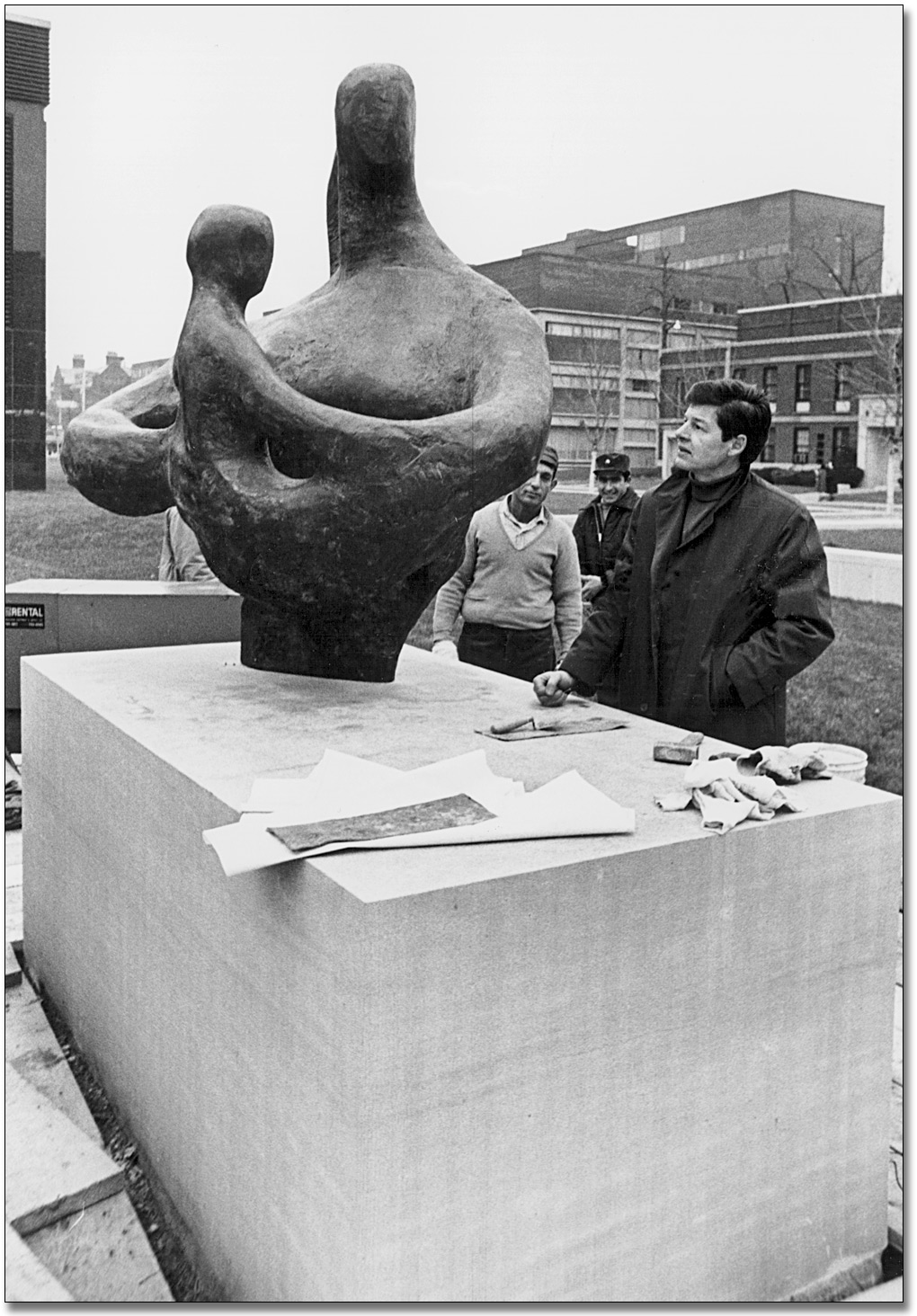 Photo: Jack Harman oversees the installation of his sculpture, Mother and Child, on the west side of the Macdonald Block, 1968