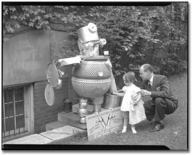 Photo: The Aluminum Victory Campaign, 1941 [man and girl looking at sculpture made out of aluminium]