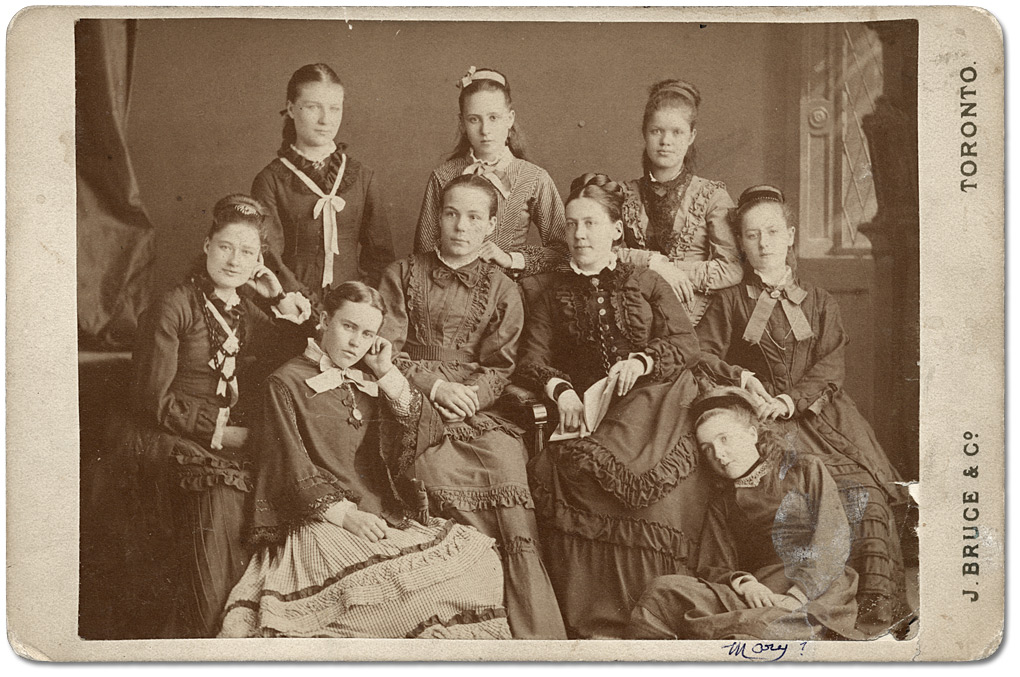 Photo: [Bessie Gregg (teacher) with senior class in Mission School], [between 1875 and 1885]