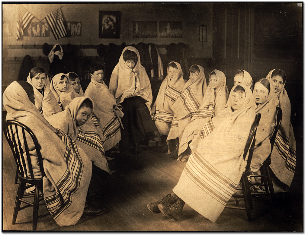 Photo: Children wrapped in blankets waiting for a visit from the school nurse, [ca. 1905]