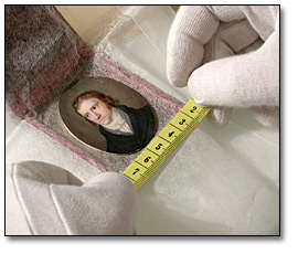 Image of hands measuring a miniature