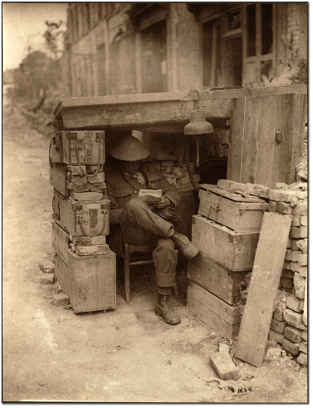 Une sentinelle canadienne à son poste composé de caisses de munitions et de briques de vieilles maisons, [vers 1918] 

